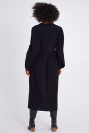 Model Olivia wearing size 10 of the For Love And Dancing Dress in colour Black (Black), from the back