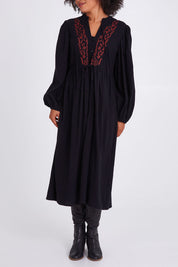 Model Olivia wearing size 10 of the For Love And Dancing Dress in colour Black (Black), from the front, cropped image