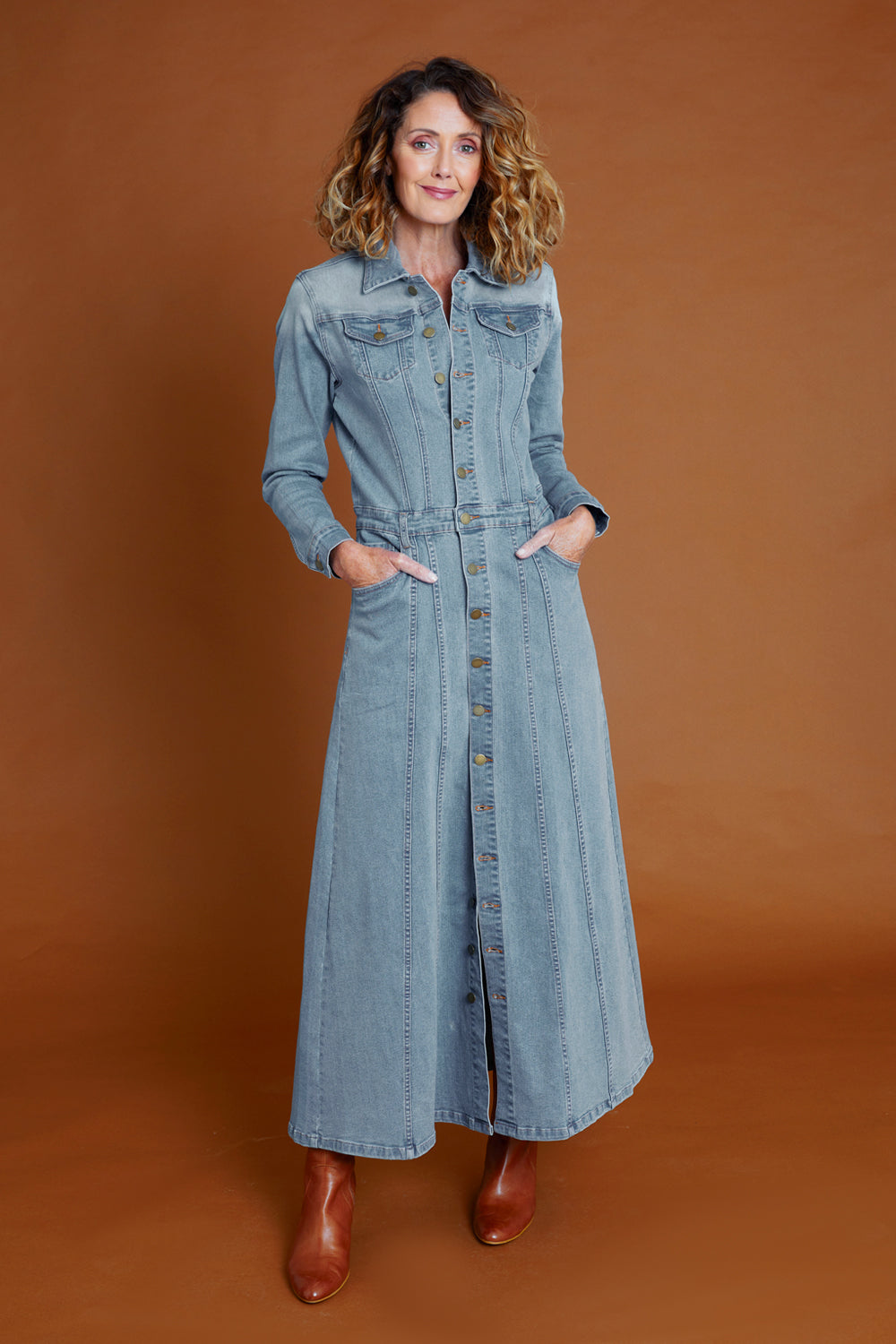 Model Emma wearing size 10 of the Calamity Denim Maxi Dress in colour Denim (Blue), from the front, showing the whole outfit