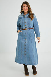 Model Laura wearing size 14 of the Calamity Denim Maxi Dress in colour Denim (Blue), from the front, showing the whole outfit
