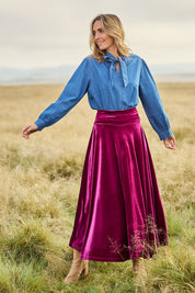 Model Tegan wearing size 10 of the Love By Candlelight Velvet Skirt in colour Mulberry (Pink), from the front, showing the whole outfit