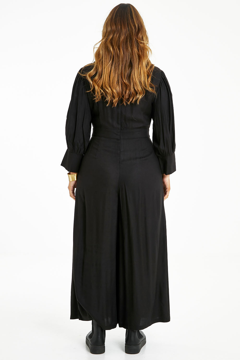 Model Laura wearing size 14 of the Feeling Super Fine Jumpsuit in colour Black (Black), from the back