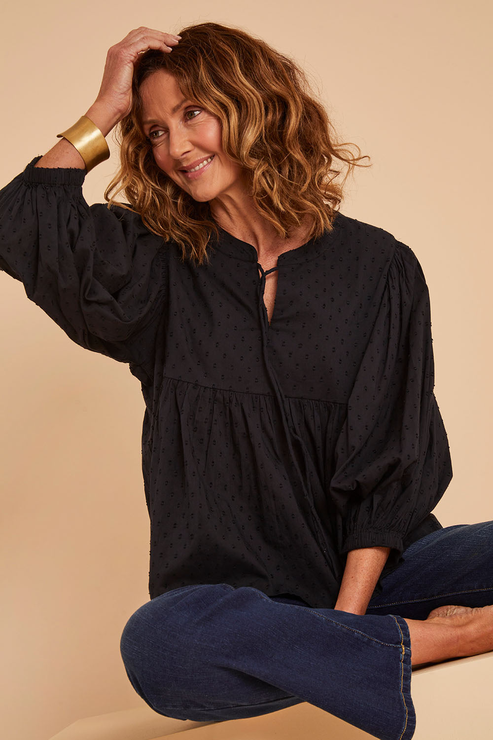 Model Emma wearing size 10 of the Happy Hour Dobby Blouse in colour Black (Black), from the front, cropped image