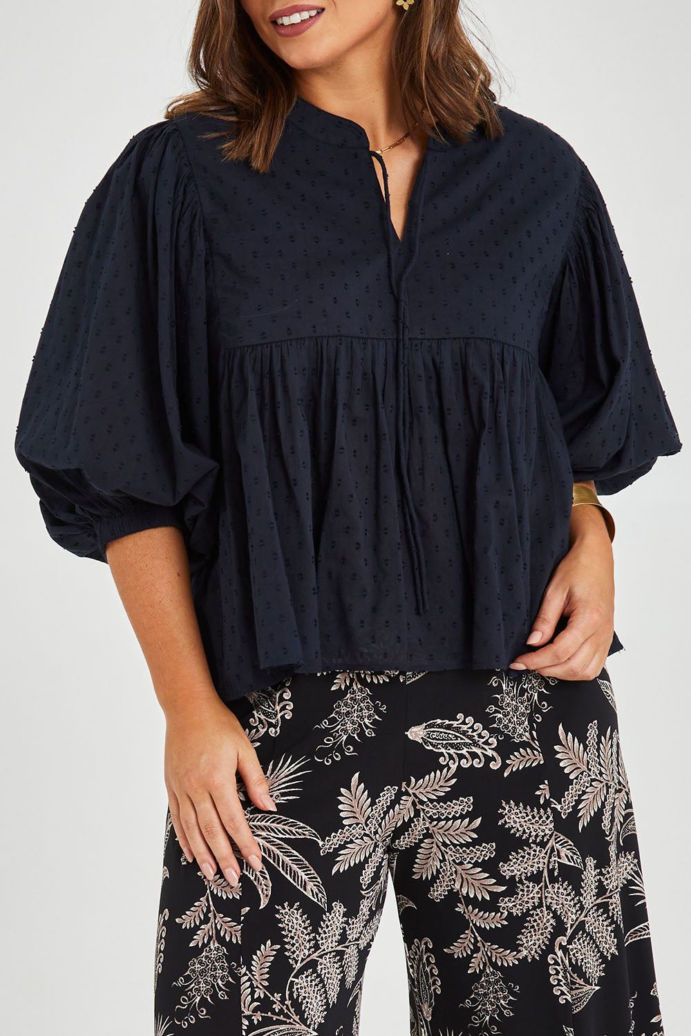 Model Monique wearing size 14 of the Happy Hour Dobby Blouse in colour Black (Black), from the front, cropped image