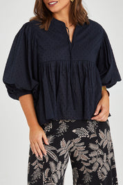 Model Monique wearing size 14 of the Happy Hour Dobby Blouse in colour Black (Black), from the front, cropped image
