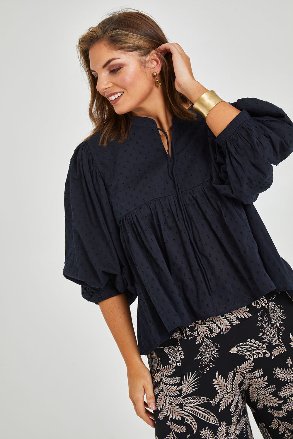 Model Monique wearing size 14 of the Happy Hour Dobby Blouse in colour Black (Black), from the front, cropped image