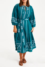 Model Monique wearing size 14 of the Spring Fling Embroidered Dress in colour Jade (Green), from the front, cropped image