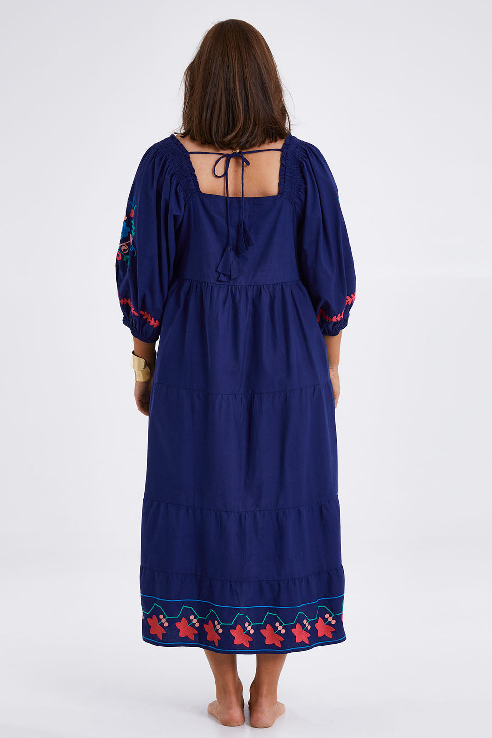 Model Monique wearing size 14 of the Picnic In The Fields Embroidered Dress in colour Navycombo (Blue), from the back