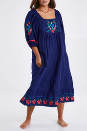 Model Monique wearing size 14 of the Picnic In The Fields Embroidered Dress in colour Navycombo (Blue), from the front, cropped image