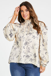 Model Laura wearing size 14 of the Teatime And Flowers Blouse in colour Cream (White), from the front, cropped image