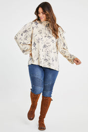 Model Laura wearing size 14 of the Teatime And Flowers Blouse in colour Cream (White), from the front, showing the whole outfit