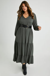 Model Laura wearing size 14 of the Tiered Delight Bamboo Dress in colour Combat (Green), from the front, showing the whole outfit