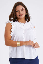 Model Monique wearing size 14 of the Summer Sun Ruffle Blouse in colour White (White), from the front, cropped image