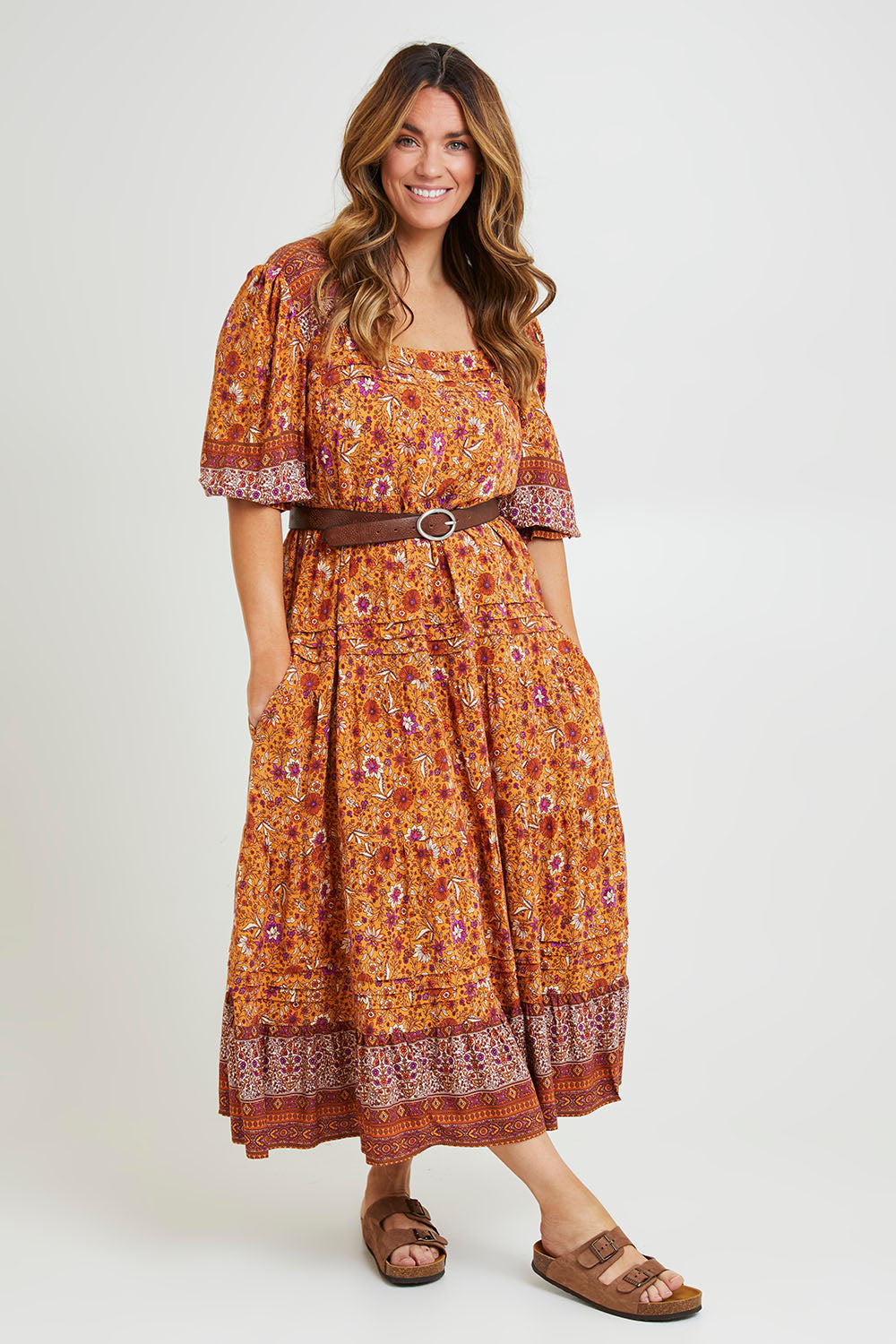 Model Laura wearing size 14 of the Paradise Found Maxi Dress in colour Rustfleur, from the front, showing the whole outfit