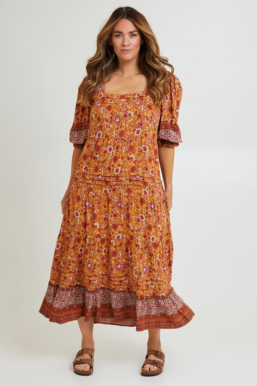 Model Laura wearing size 14 of the Paradise Found Maxi Dress in colour Rustfleur, from the front, showing the whole outfit