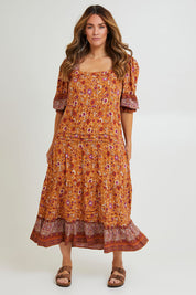 Model Laura wearing size 14 of the Paradise Found Maxi Dress in colour Rustfleur, from the front, showing the whole outfit