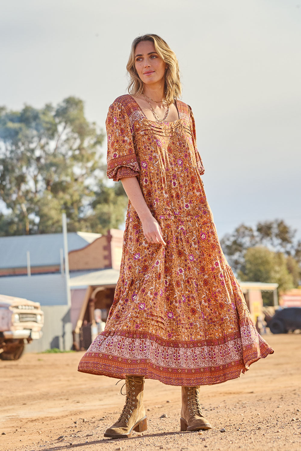 Model Tegan wearing size 10 of the Paradise Found Maxi Dress in colour Rustfleur, from the front, showing the whole outfit