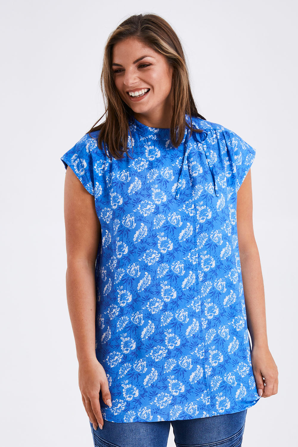 Model Monique wearing size 14 of the Forget Me Not Sleeveless Blouse in colour Bluewhite (Blue), from the front, cropped image