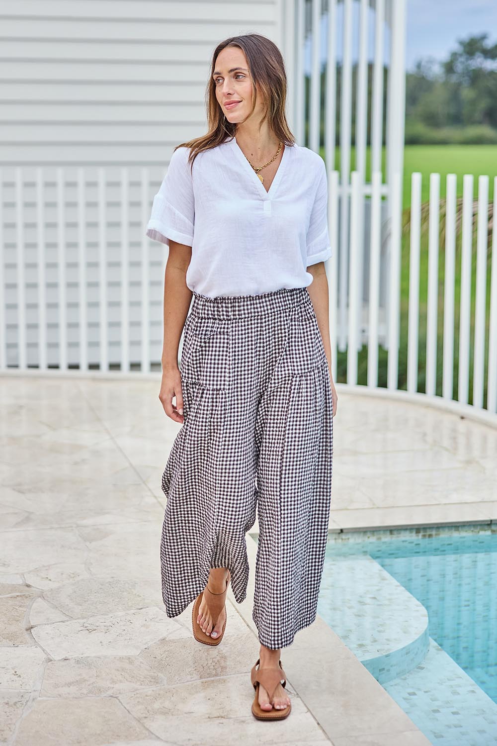Model Tegand wearing size 10 of the Break Of Day Cotton Pants - Choccheck in colour Choccheck, from the front