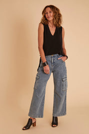 Model Emma wearing size 10 of the Snuggle Up Vest in colour Black (Black), from the front, showing the whole outfit