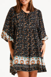 Model Monique wearing size 14 of the Sunset Dreamer Dress in colour Blkfleur (Black), from the front, cropped image