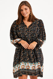 Model Monique wearing size 14 of the Sunset Dreamer Dress in colour Blkfleur (Black), from the front, cropped image