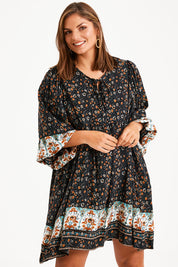 Model Monique wearing size 14 of the Sunset Dreamer Dress in colour Blkfleur (Black), from the front, cropped image
