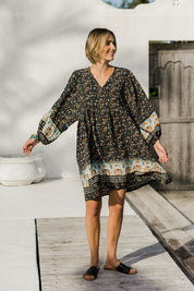Model Tegan wearing size 10 of the Sunset Dreamer Dress in colour Blkfleur (Black), from the front, showing the whole outfit