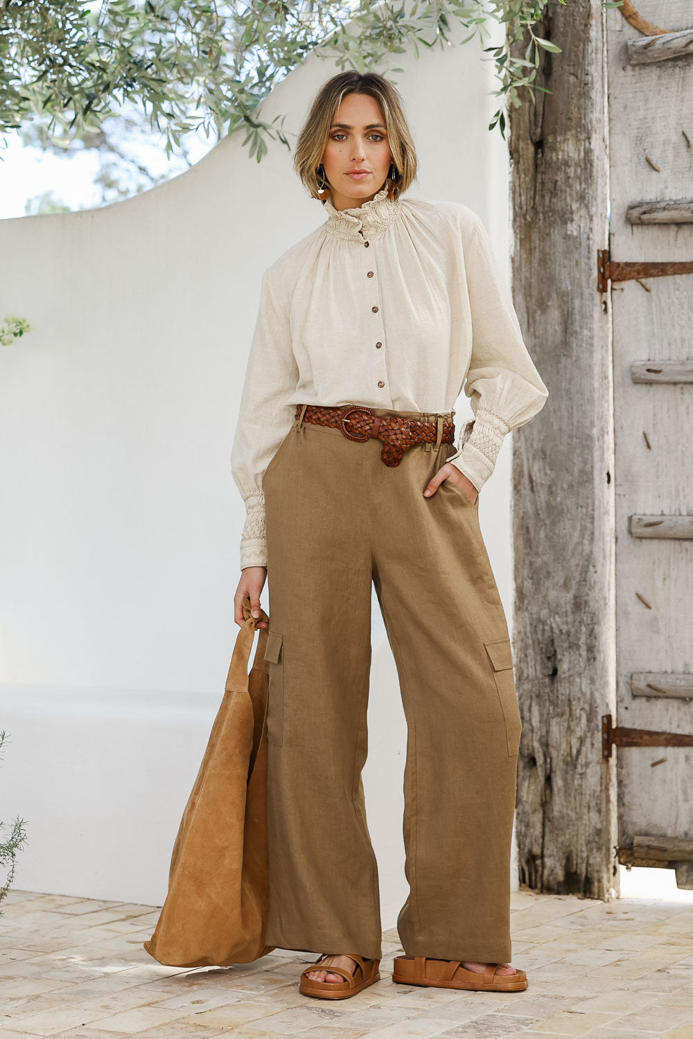 Model Tegan wearing size 10 of the Always In Style Linen Cargo Pant in colour Camel, from the front, showing the whole outfit