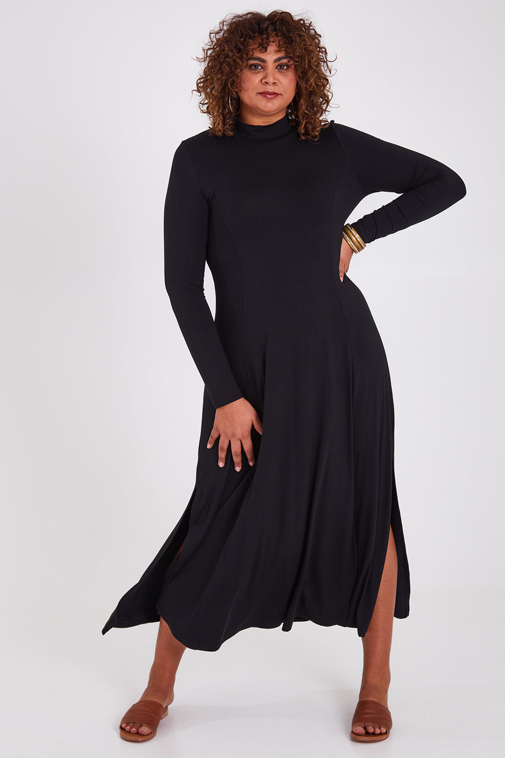 Model Anucia wearing size 14 of the My Faithful Maxi Tee Skivvy Dress in colour Black (Black), from the front, showing the whole outfit