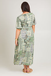 Model Poppy wearing size 16 of the All I Need Is You Mid Sleeve Dress in colour Mintpatch (Green), from the back