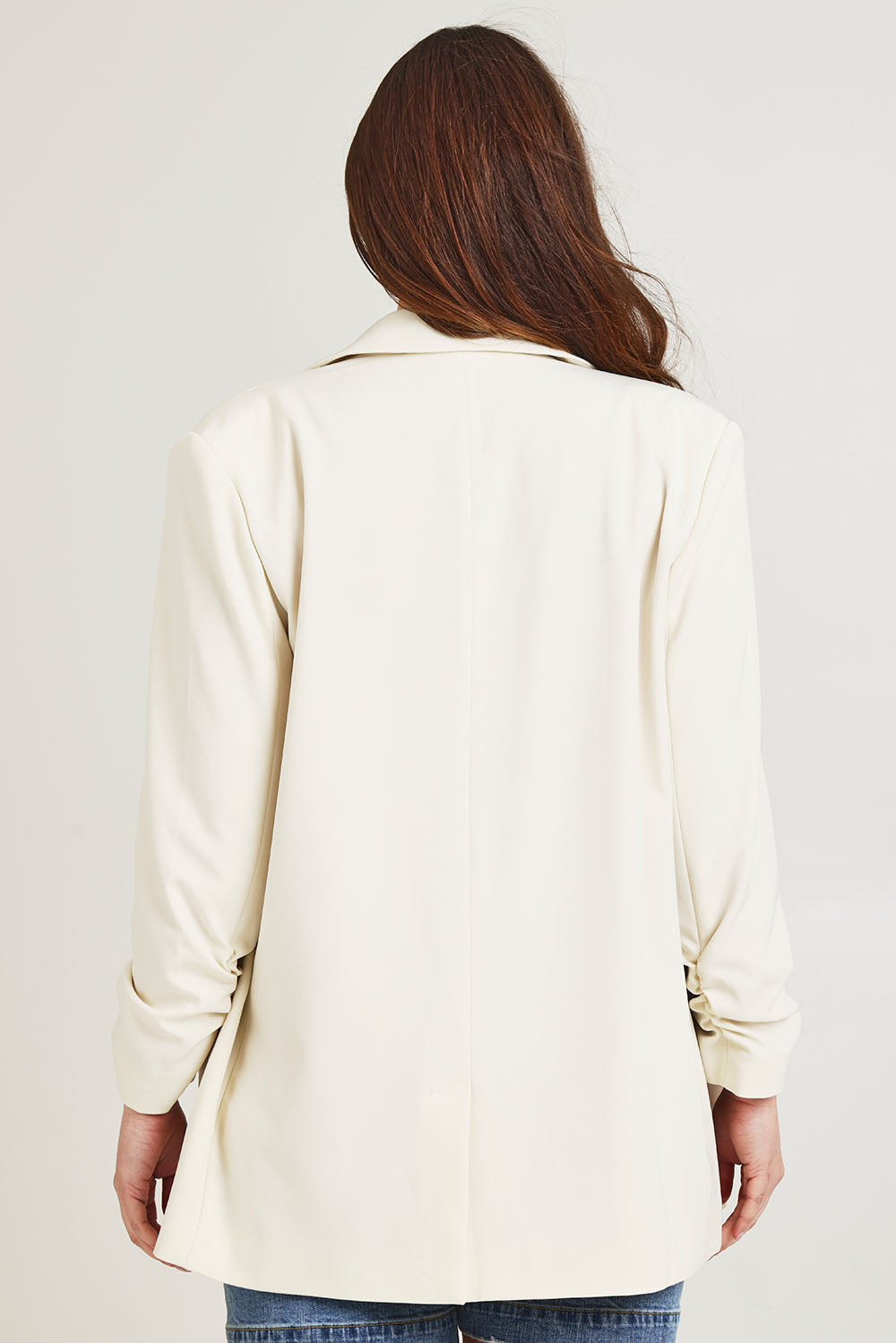 Model Jane wearing size 14 of the Elegant Persuasion Ruched Sleeved Oversized Blazer in colour Cream, from the back