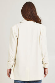 Model Jane wearing size 14 of the Elegant Persuasion Ruched Sleeved Oversized Blazer in colour Cream, from the back