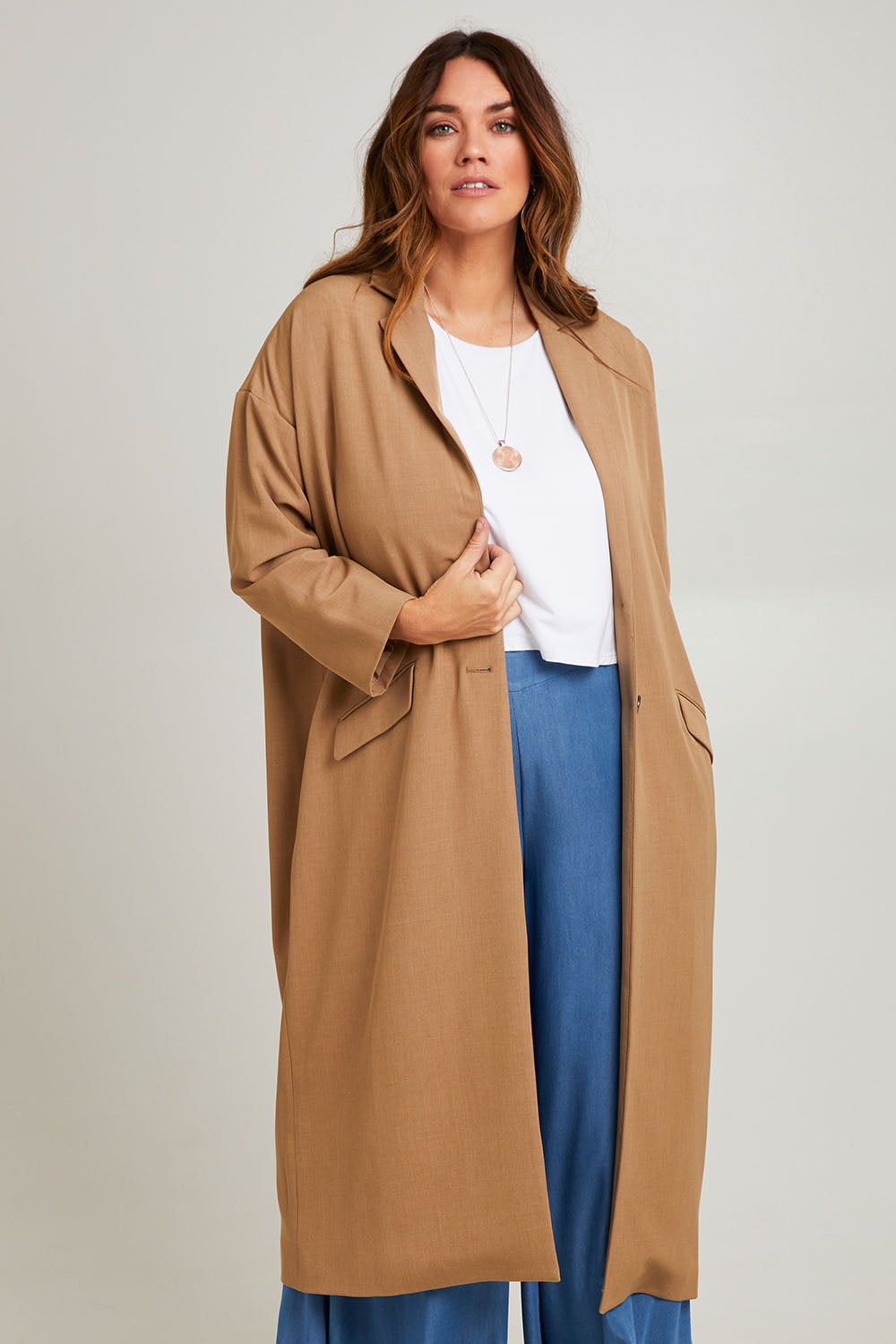 Model Laura wearing size 14 of the Suits Me Long Jacket in colour Earth, from the front, cropped image