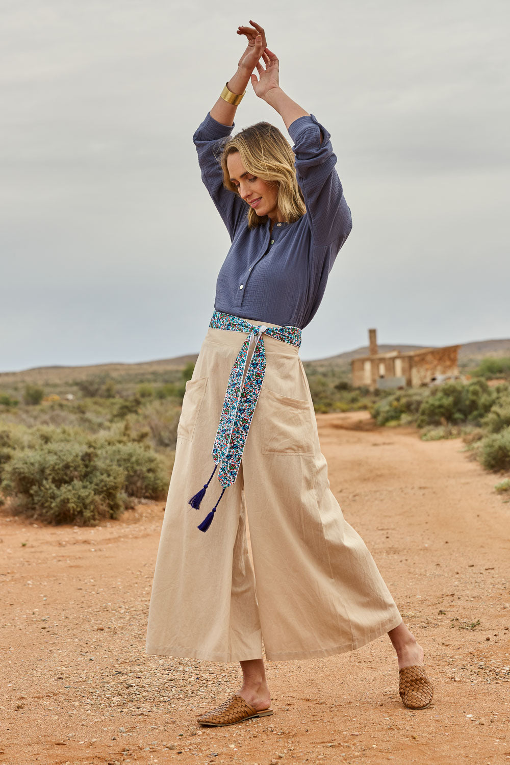 Model Tegan wearing size 10 of the Serene Day Wide Leg Pants in colour Sand, from the front, showing the whole outfit
