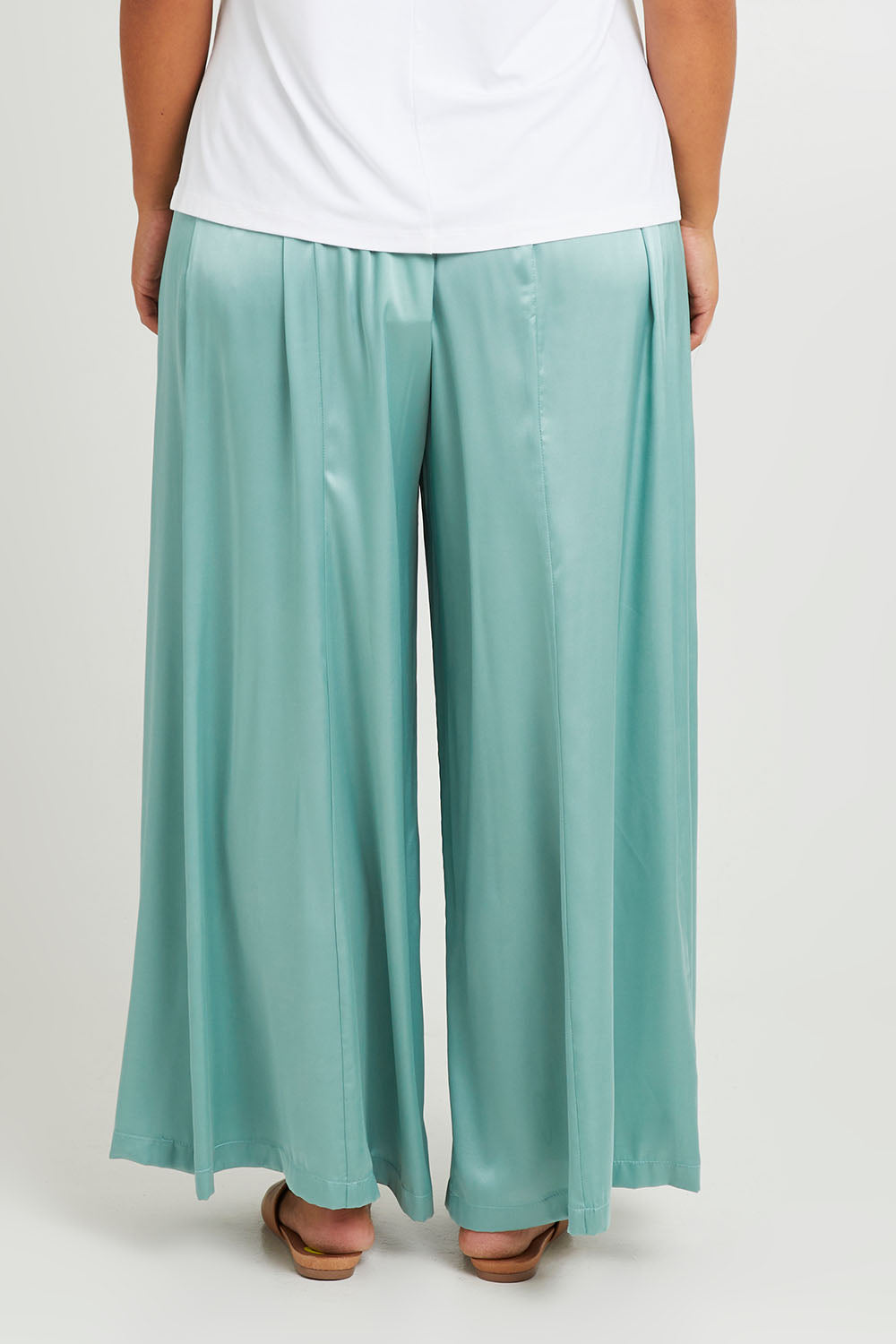 Model Monique wearing size 14 of the Going With The Flow Wide Leg Pants in colour Sage (Green), from the back