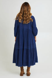 Model Laura wearing size 14 of the Real Love Tiered Dress in colour Denim (Blue), from the back