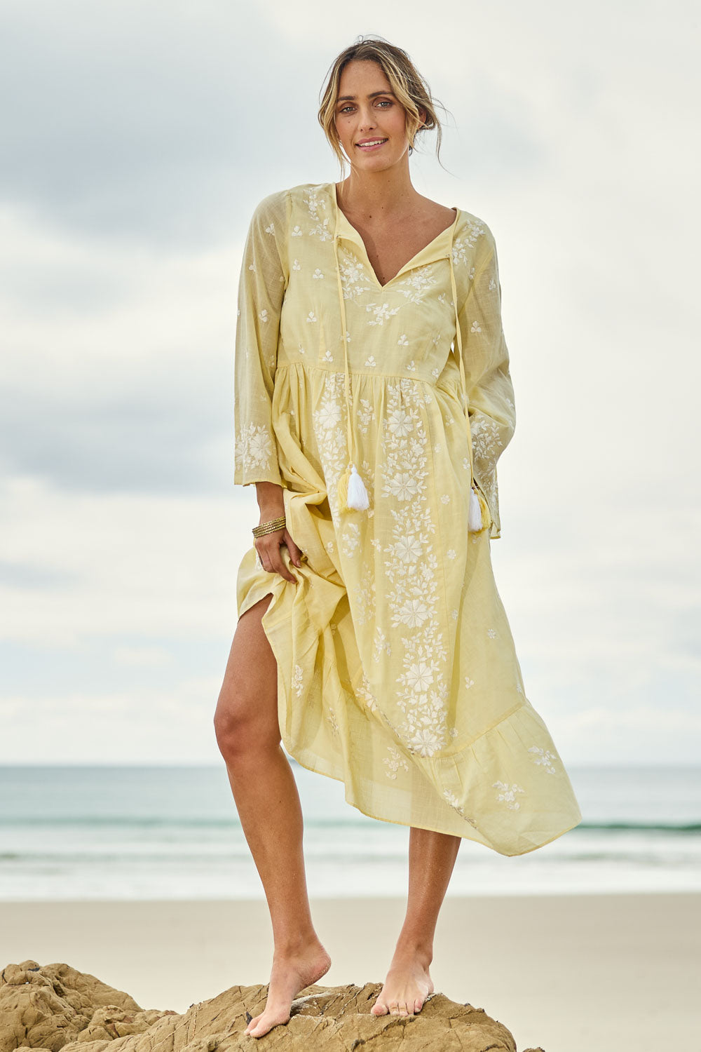 Model Tegan wearing size 10 of the Dancing With Joy Dress in colour Lemon, from the front, showing the whole outfit