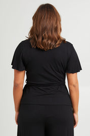 Model Monique wearing size 14 of the All For You Wrap Top in colour Black (Black), from the back