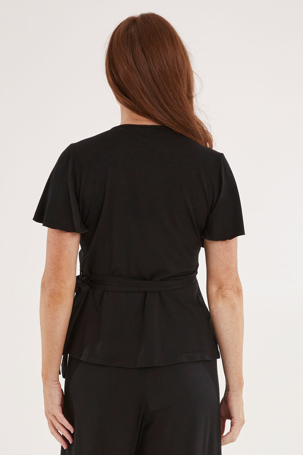 Model Sally wearing size 10 of the All For You Wrap Top in colour Black (Black), from the back