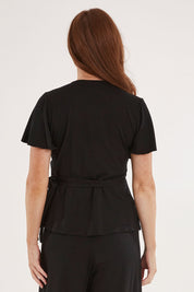 Model Sally wearing size 10 of the All For You Wrap Top in colour Black (Black), from the back
