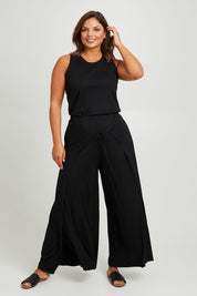 Model Monique wearing size 14 of the All For You Wrap Pants in colour Black (Black), from the front, showing the whole outfit