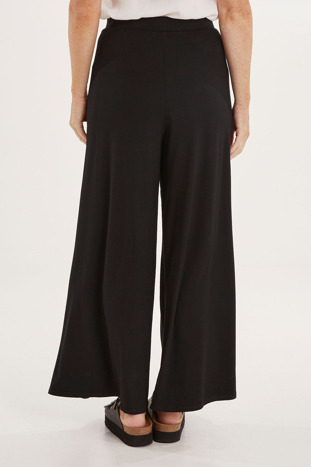 Model Sally wearing size 10 of the All For You Wrap Pants in colour Black (Black), from the back
