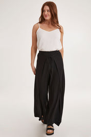 Model Sally wearing size 10 of the All For You Wrap Pants in colour Black (Black), from the front, showing the whole outfit