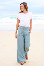 Model Bianca wearing size 10 of the High Flying Wide Leg Pants in colour Dusk (Green), from the front, showing the whole outfit