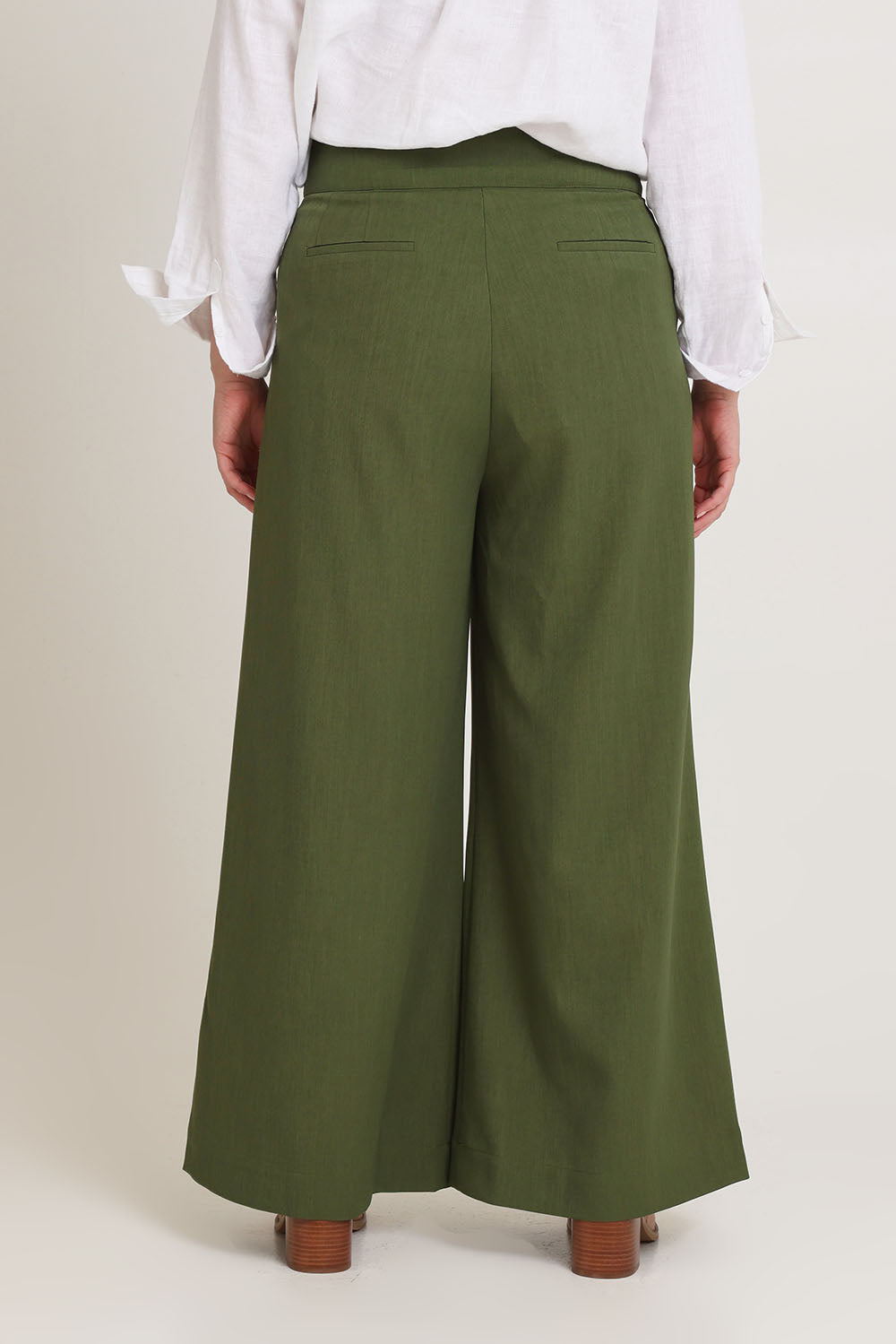 Model Chanel wearing size 16 of the High Flying Wide Leg Pants in colour Pine (Green), from the back