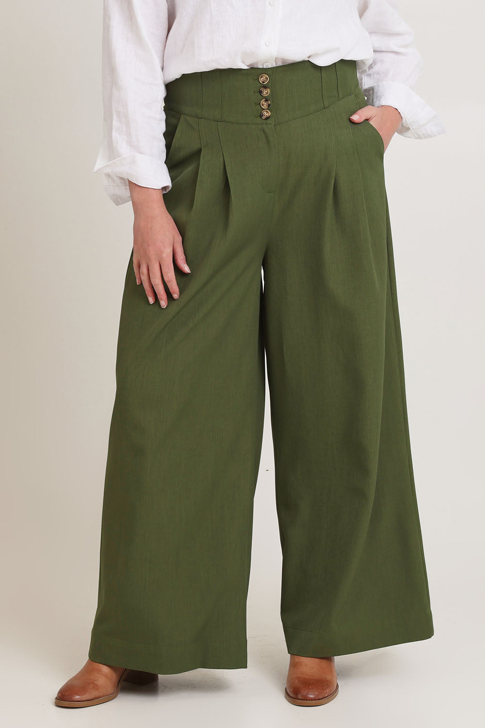 Model Chanel wearing size 16 of the High Flying Wide Leg Pants in colour Pine (Green), from the front, cropped image