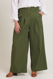 Model Chanel wearing size 16 of the High Flying Wide Leg Pants in colour Pine (Green), from the front, cropped image