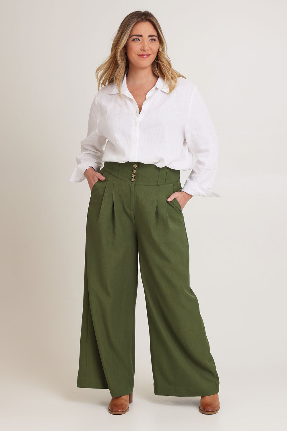 Model Chanel wearing size 16 of the High Flying Wide Leg Pants in colour Pine (Green), from the front, showing the whole outfit