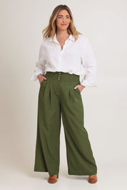 Model Chanel wearing size 16 of the High Flying Wide Leg Pants in colour Pine (Green), from the front, showing the whole outfit